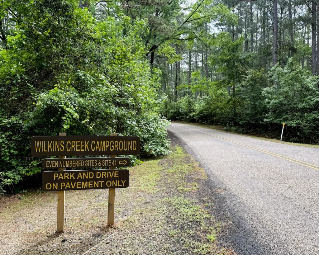 Wooden park sign for Entrance 1 of Wilkins Creek loop marking Even numbered sites.