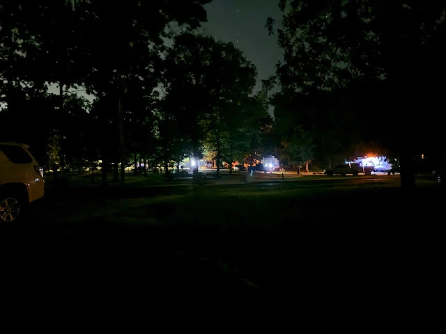 Bright blue RV LED lights illuminating a dark campsite at night