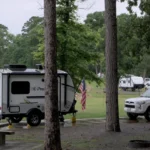 Our camper and 4Runner at a rainy campsite during our 2025 camping journey