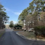 Entrance gate house at Rocky Point Park surrounded by pine trees
