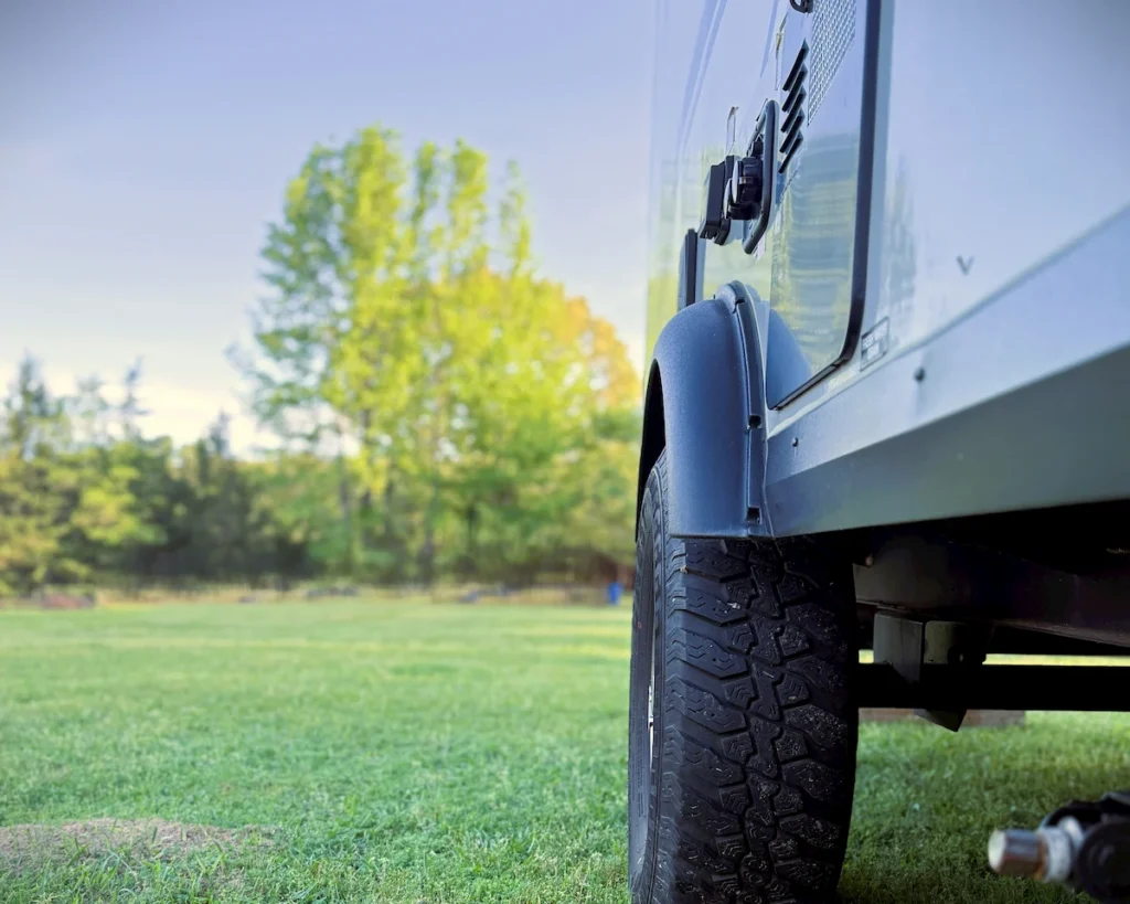 Close up of the off-road tires and independent torsion axle on a Flagstaff E-Pro 15tb camper.