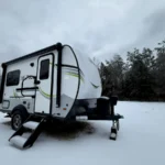 Camper covered in ice during a Texas ice storm in a driveway