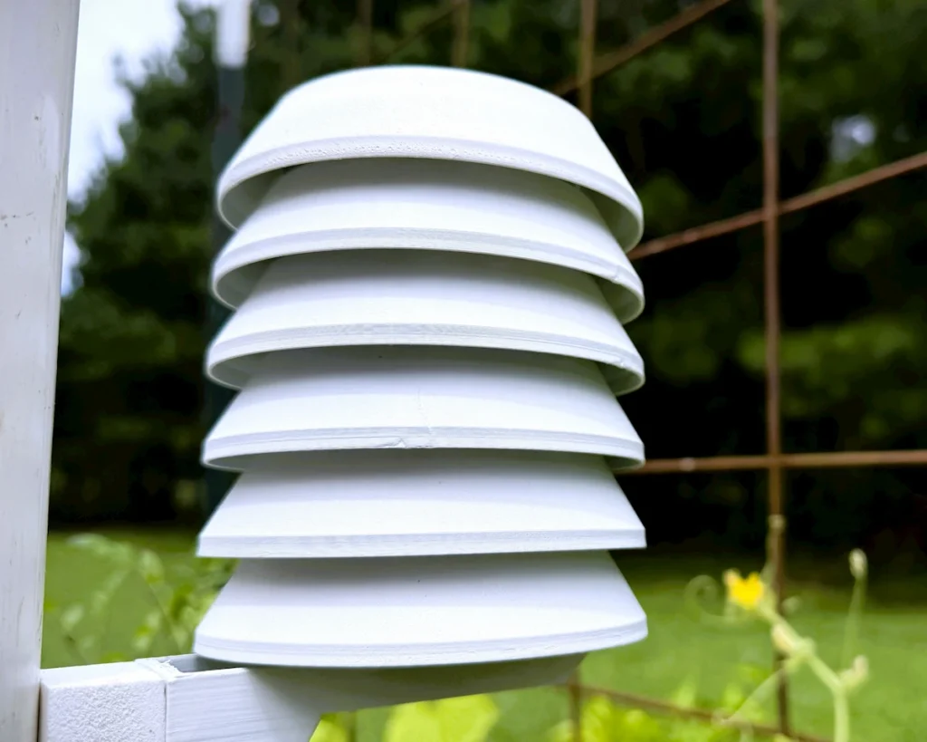 A 3D-printed Stevenson screen enclosure protecting a SwitchBot thermo-hygrometer as part of a DIY weather sensors build.