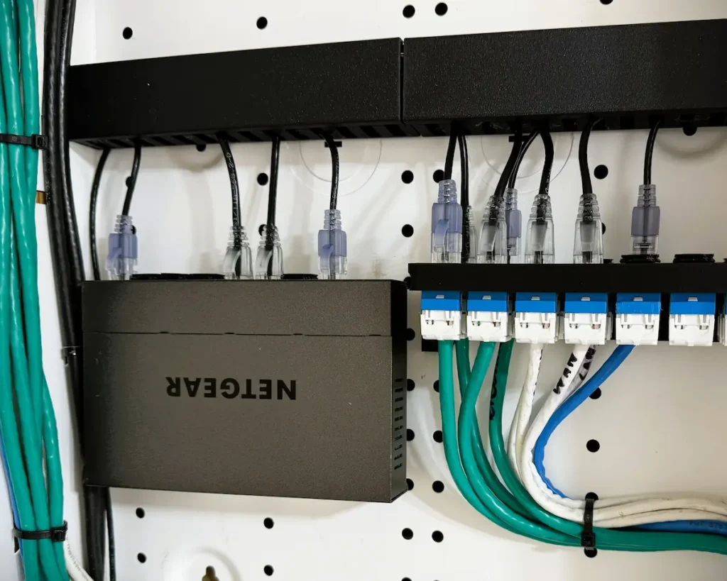 Structured media center enclosure in the wash room showing a network switch powered via Power over Ethernet.