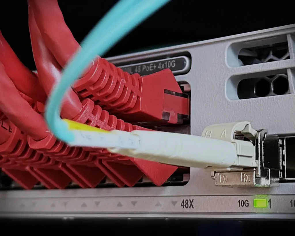 A racked network switch delivering packets reliably behind the scenes, demonstrating that the Dead Internet Theory is a failure of content, not connectivity.